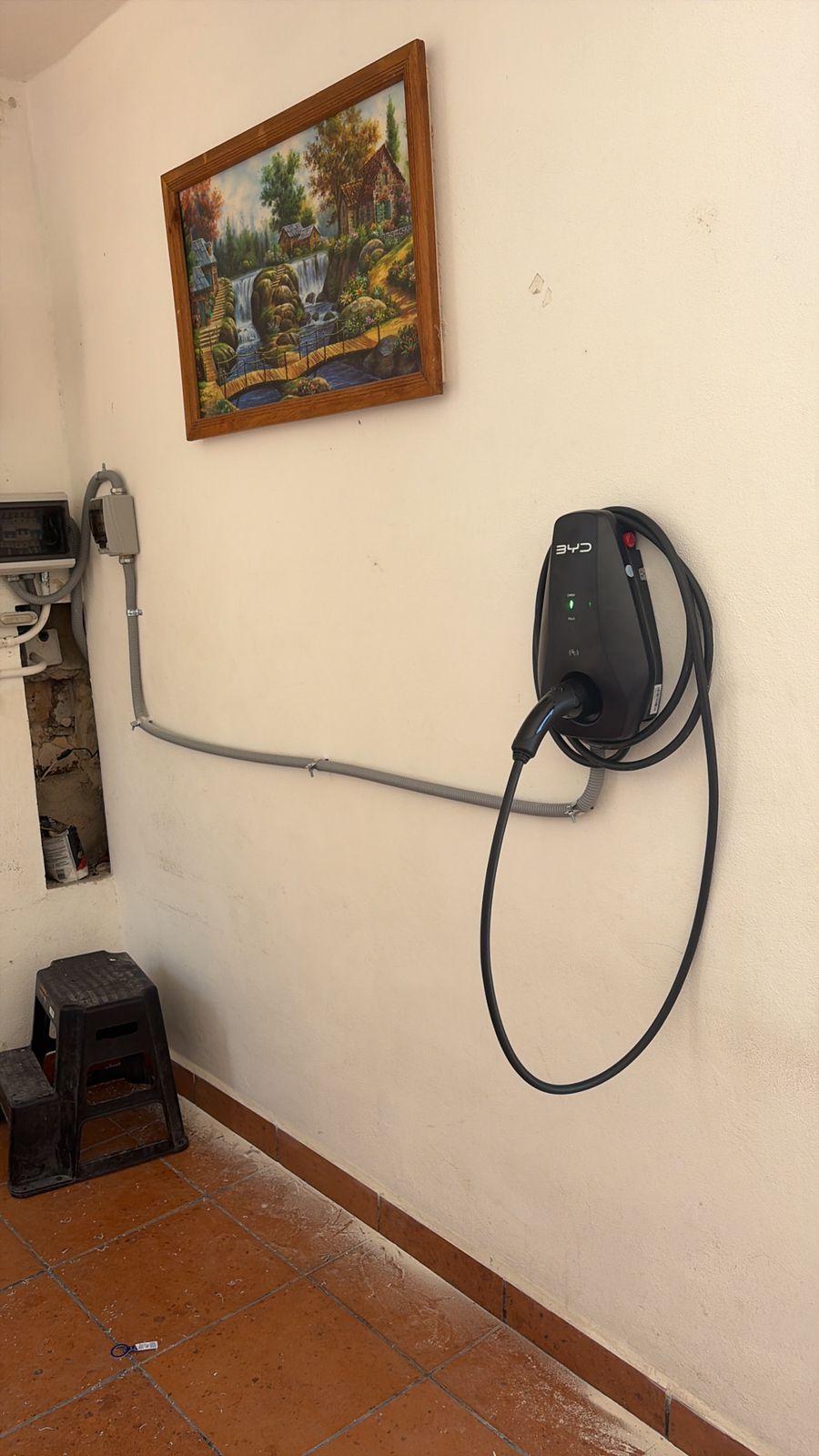 Cargador BYD instalado en pared interior con canalización